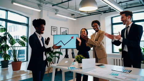 diverse business team celebrates success and growth in office meeting