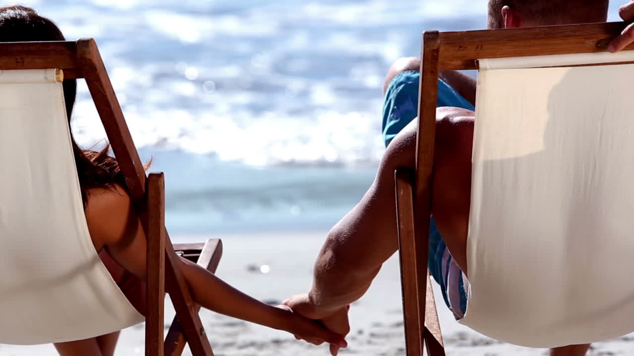 Lovely couple sitting on the beach