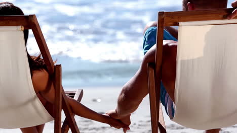 lovely couple sitting on the beach