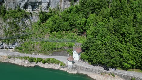 aerial shot of cars passing on a highway near klöntalersee great lake, glarus canton, switzerland