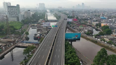 aerial view of a city highway with canal and residential areas