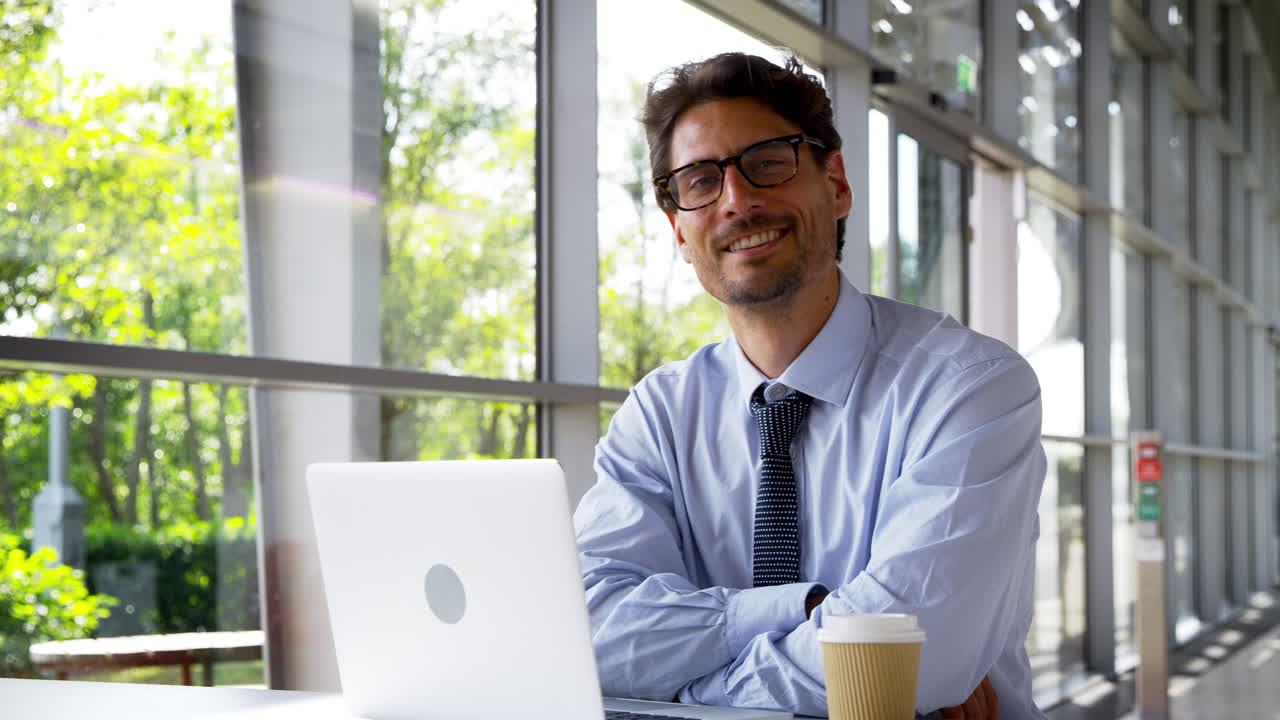 Portrait of businessman working on laptop in modern office Premium ...
