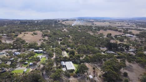 drone aerial over the country town of victor harbour with smoke from a fire