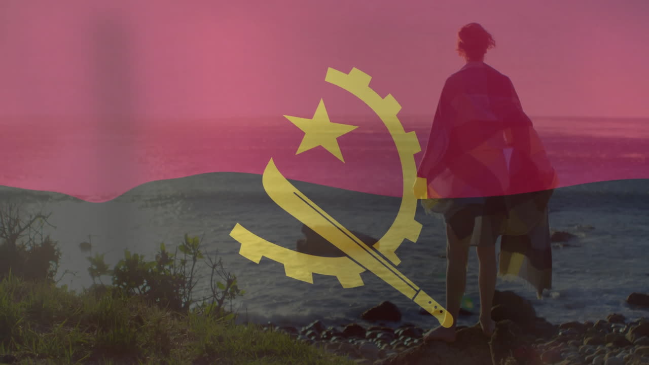 Angola flag overlay on silhouette of person by ocean during sunset animation