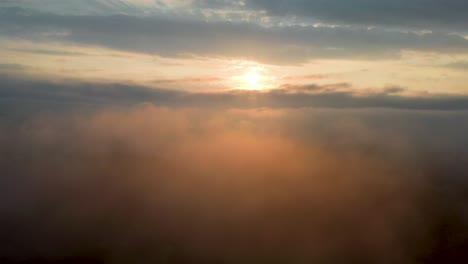 heavenly clouds with vibrant colors from morning sunrise, high aerial