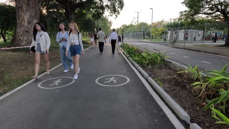 people walking together on a park pathway