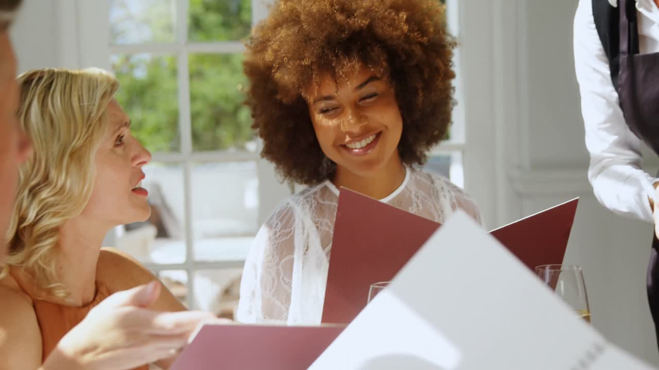 Friends placing order to waitress