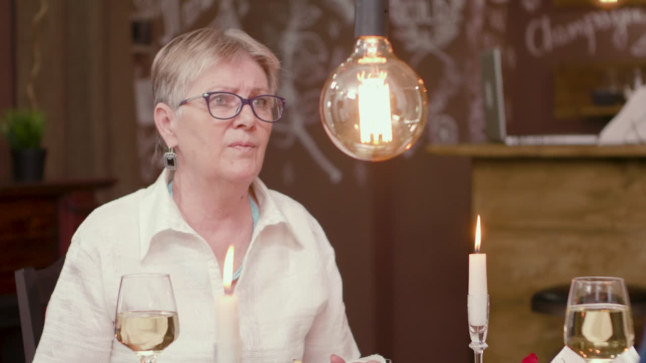 Woman at a candlelit dinner in a restaurant