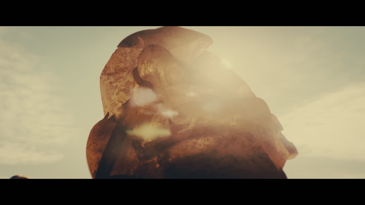 Huge golden statues in the desert during sunset