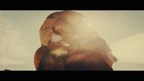 huge golden statues in the desert during sunset