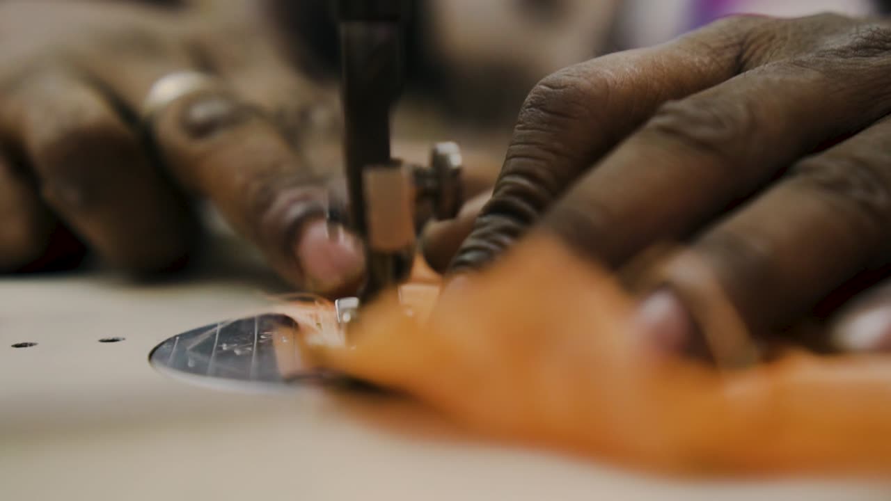 Hands Of Tailor Using Sewing Machine In Tekka Centre, Singapore - close up shot