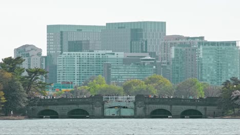 Key-bridge-in-Washington-DC-with-tourists-walking-on-it-and-the-skyscrapers-in-the-background