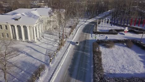 snowy city street with historical building