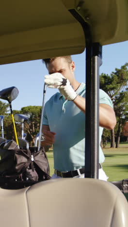 male golfer removing golf club from golf bag
