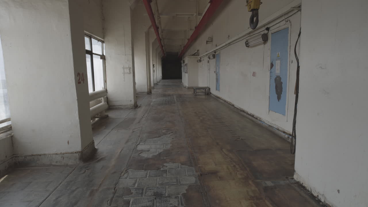 Long, Empty, And Dilapidated Hallway Inside The Chernobyl Nuclear Power Plant Site In Ukraine. - wide shot