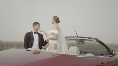 romantic wedding couple in a convertible