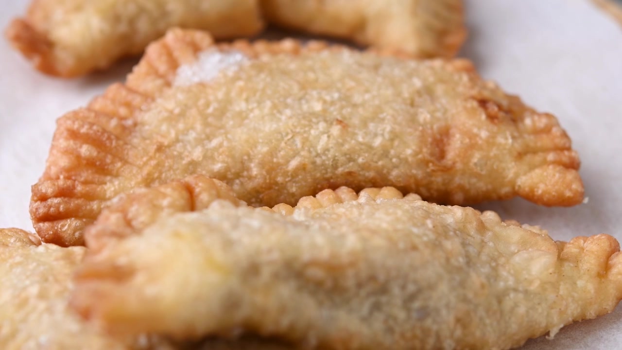 Homemade sweet pumpkin empanadillas rotating