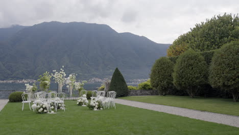 elegant outdoor wedding ceremony by the lake with mountain view