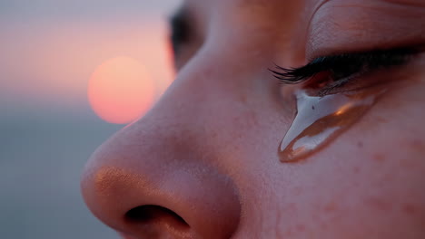 close-up of a crying eye at sunset
