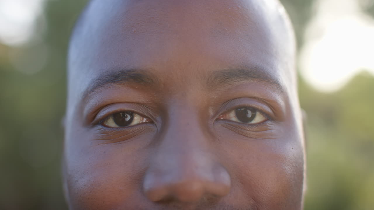 Close-up of man's face, focusing on eyes and facial expression outdoors