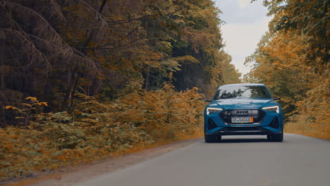 front view of a luxury car moving on the road in daylight. new electric car audi e-tron driving on the highway.