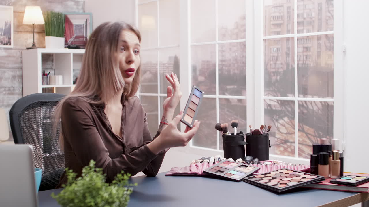 Woman with Makeup Palette and Brushes