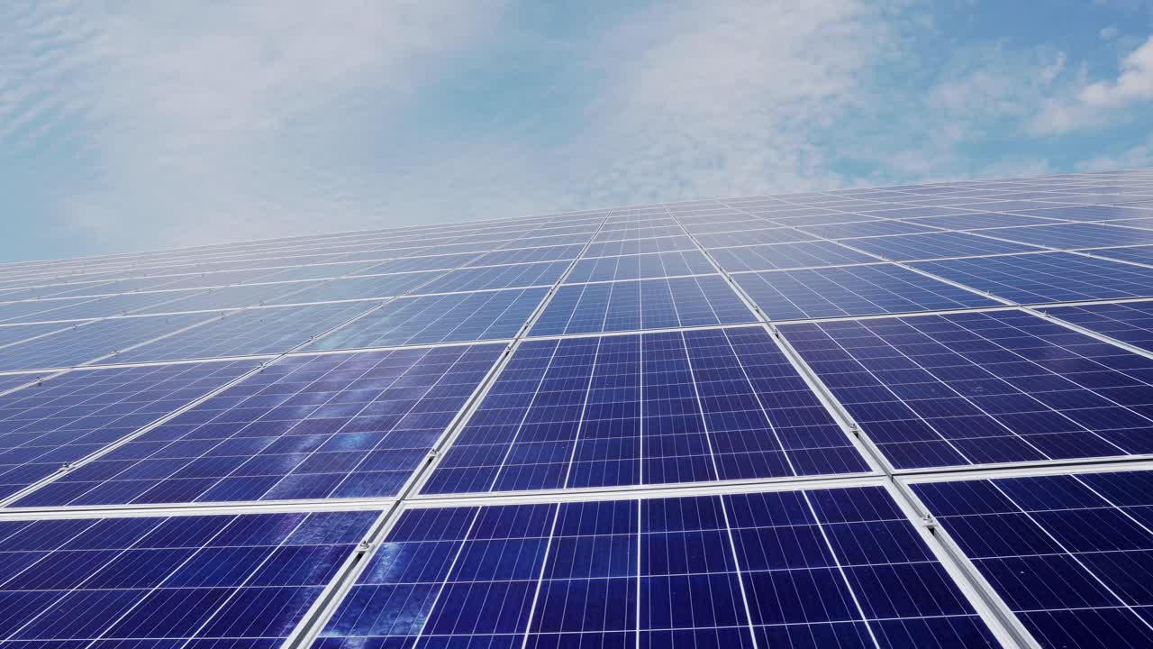 solar farm from a large number of panels on a background of blue sky with clouds. Green energy