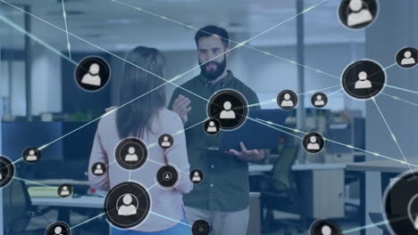 Animation-of-network-of-connections-with-icons-over-diverse-people-in-office