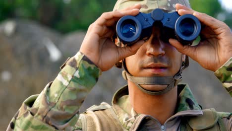 Front-view-of-young-caucasian-military-soldier-observing-on-field-during-military-training-4k