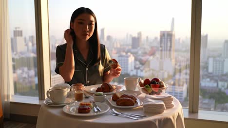 Morning Delight: A Relaxing Breakfast Experience with Pastries, Fruits, and a Scenic View Over the City Skyline, Perfectly Captured in Two Frames