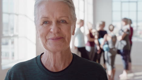 portrait happy elderly caucasian woman enjoying yoga class smiling cheerful middle aged female practicing healthy fitness lifestyle in workout studio