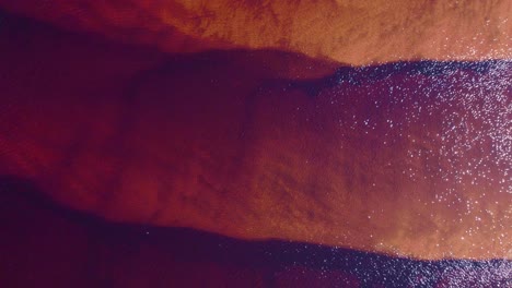aerial abstract of vibrant red and orange water surface