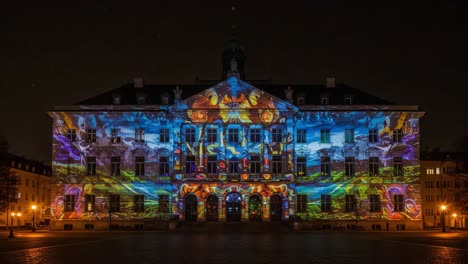 captivating light show: a stunning projection of colors and patterns on the historic building facade, transforming the architecture into a vivid canvas at night