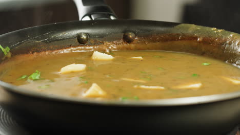 cooking traditional indian meal palak panir with spinach and cheese close up. palak paneer is an indian dish, consisting of paneer in a thick paste made from pureed spinach, palak paneer is prepared by first boiling and pureeing spinach.