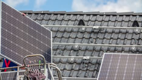 roofer lifting solar panel from lift crane to place on roof