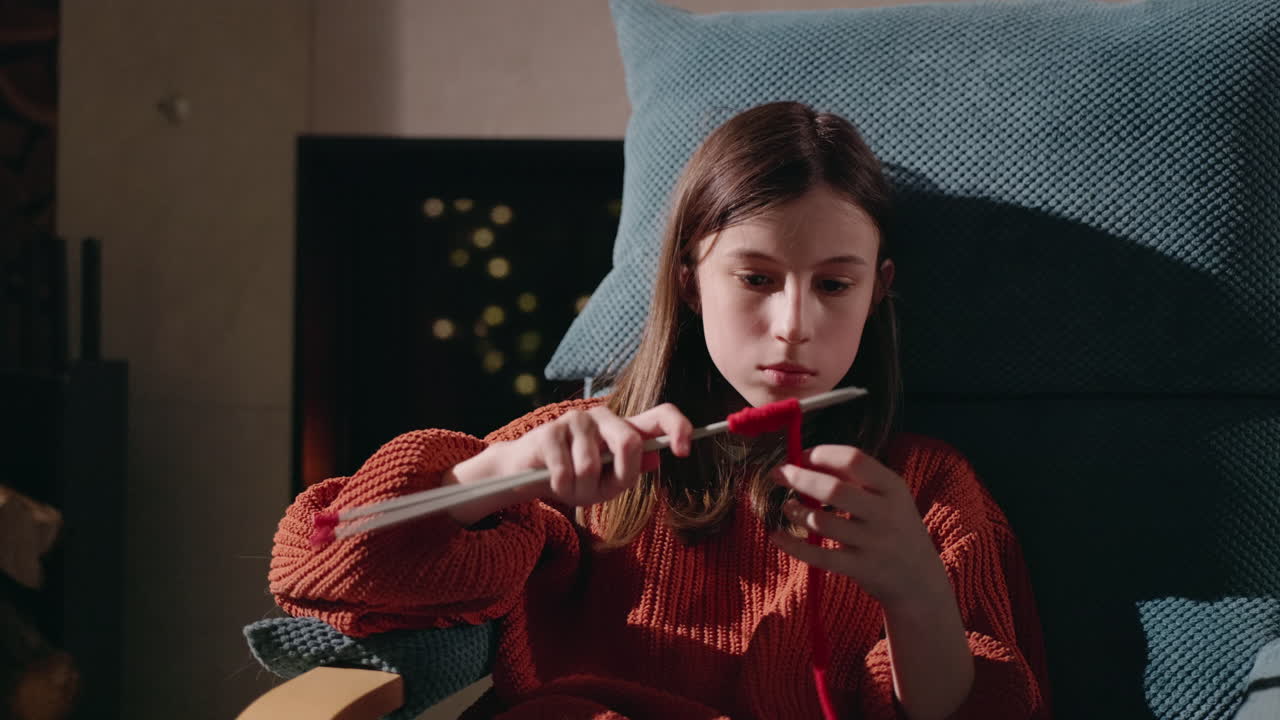 Girl Knitting with Red Yarn