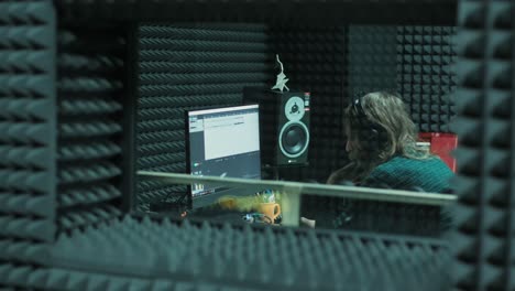 sound engineer working at mixing panel in the boutique recording studio.