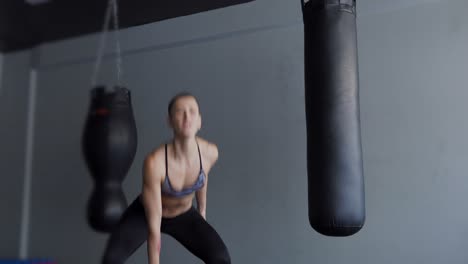 woman working out with kettlebell in gym