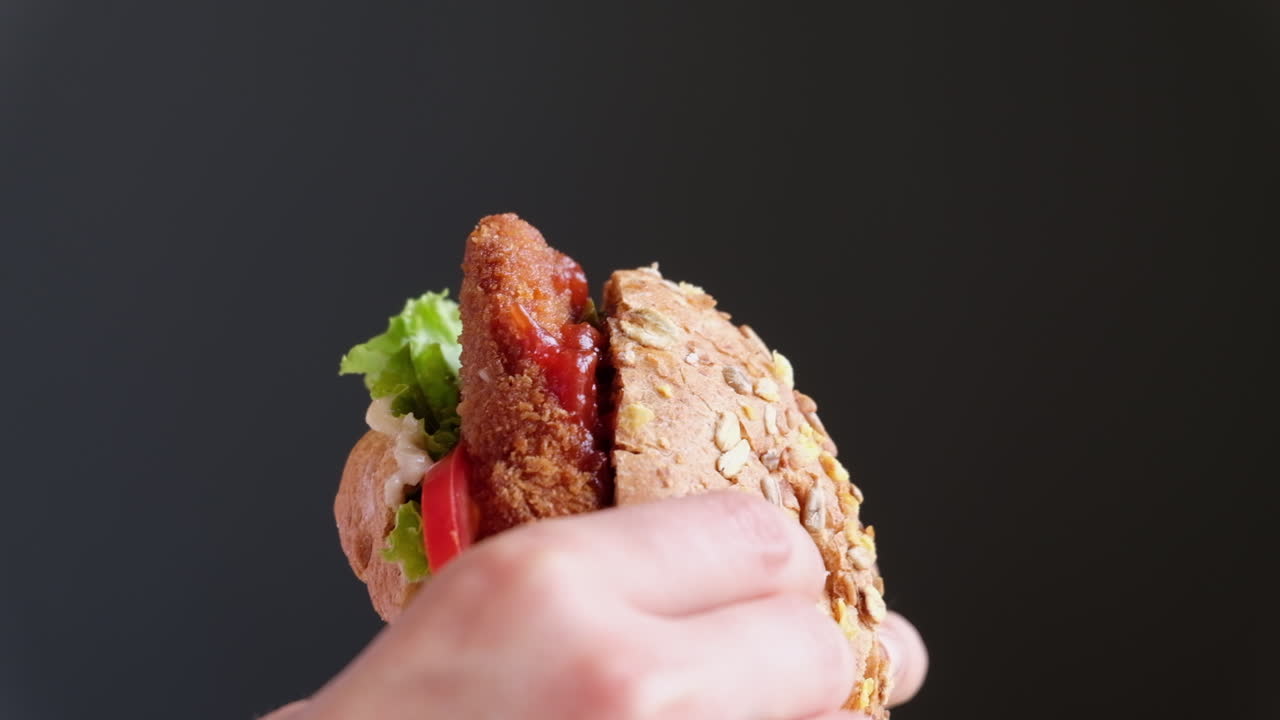 Close up of a woman eating a home made hamburger
