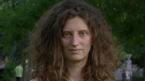 young woman staring at the camera showing neutral emotions and smiling