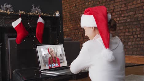 Caucasian-woman-spending-time-at-home-wearing-santa-hat