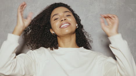 happy woman dancing with wireless earphones