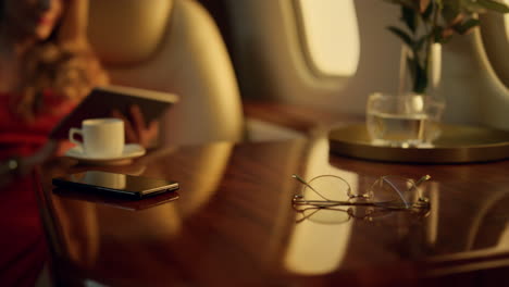 Businesswoman-working-tablet-computer.-Closeup-luxury-airplane-interior-details