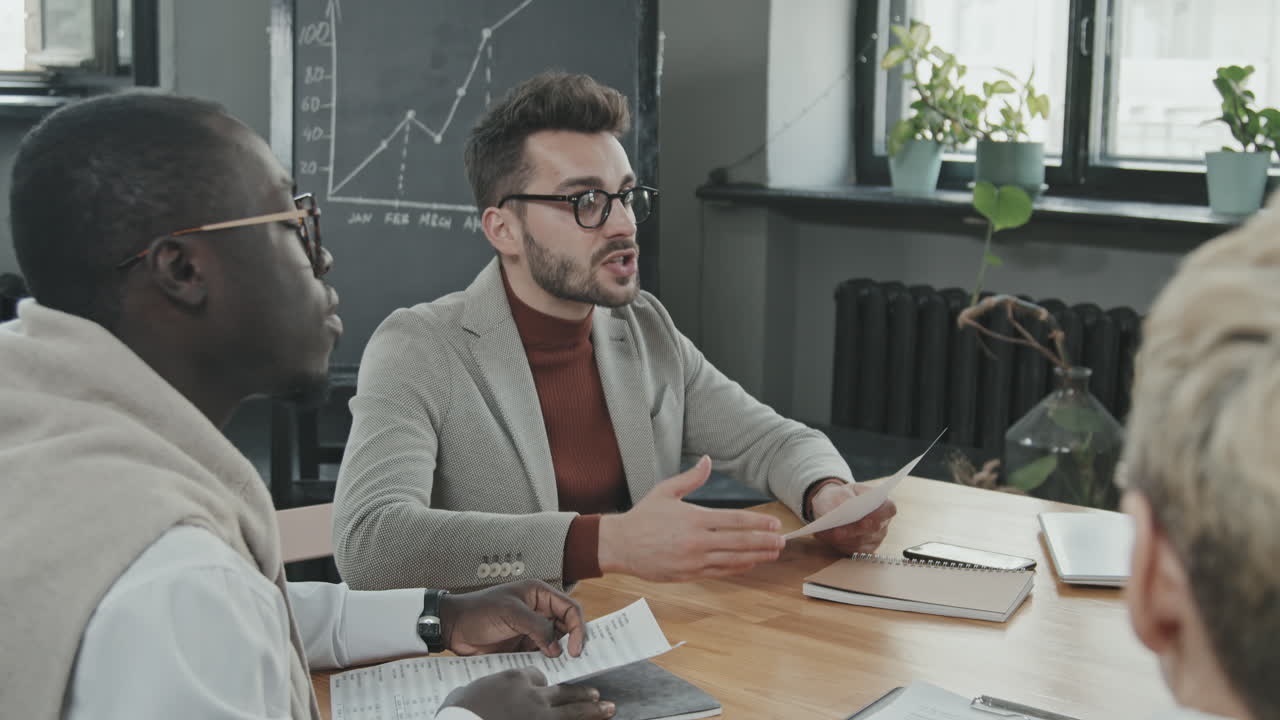 Empresário discutindo documentos com parceiros multiétnicos