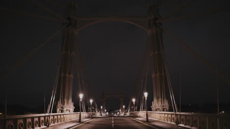 empty street bridge over river thames in london at night, england