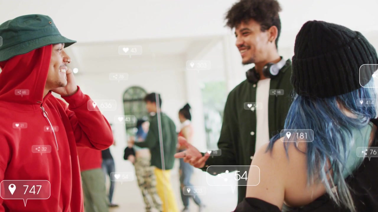 Man in red hoodie on call, making social overlays showing likes, friend arriving for handshake