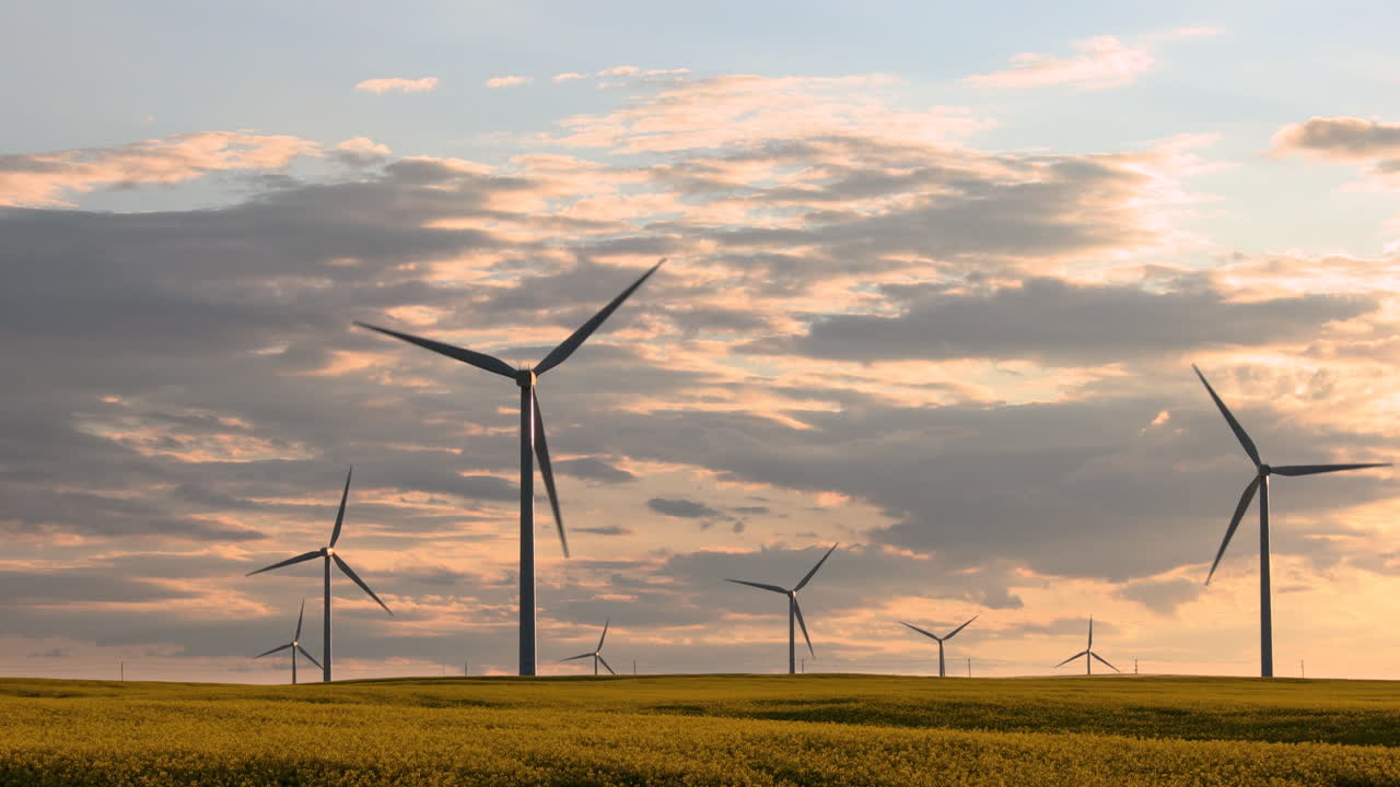 Sunset over the tall wind towers of Saskatchewan, Canada - wide