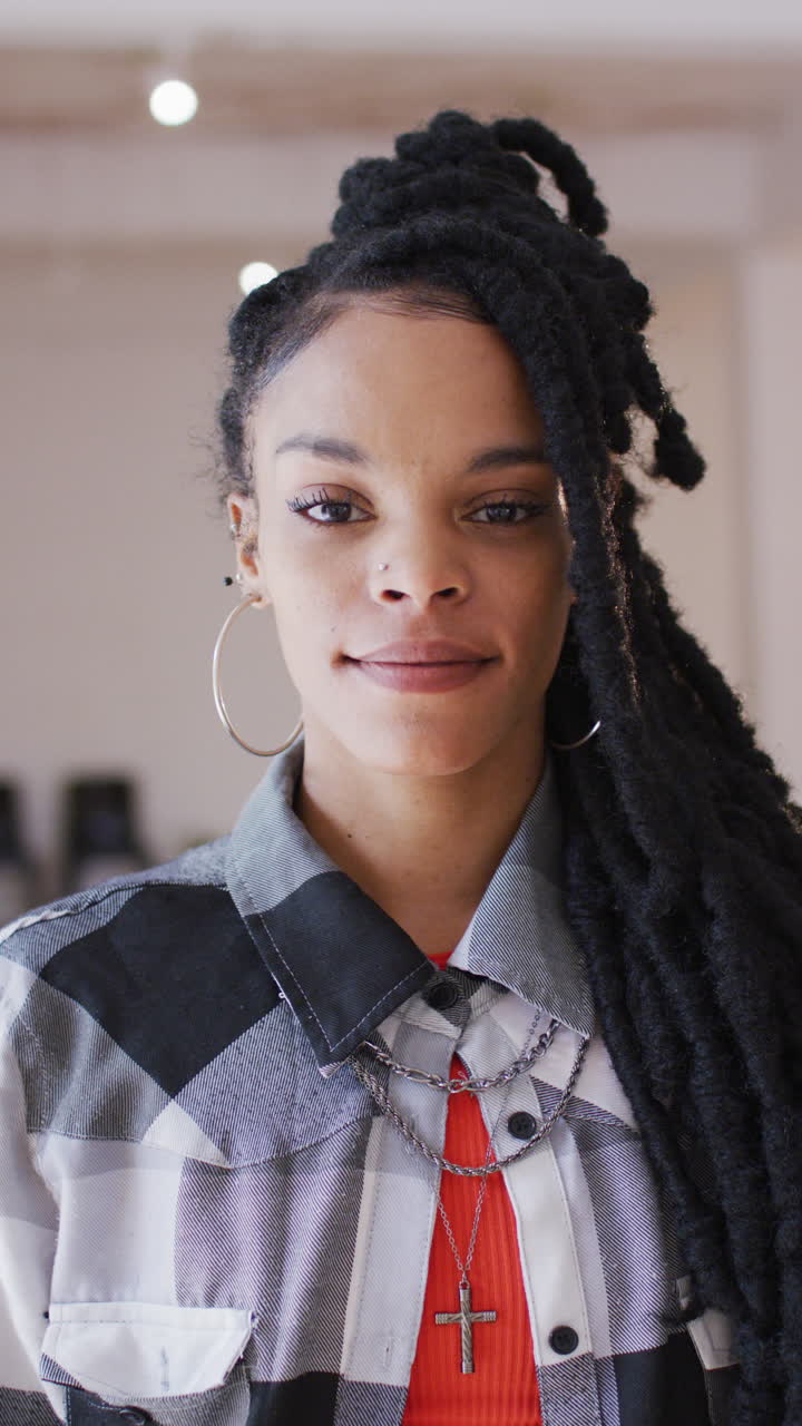 Vertical video of portrait of happy biracial woman in dance studio