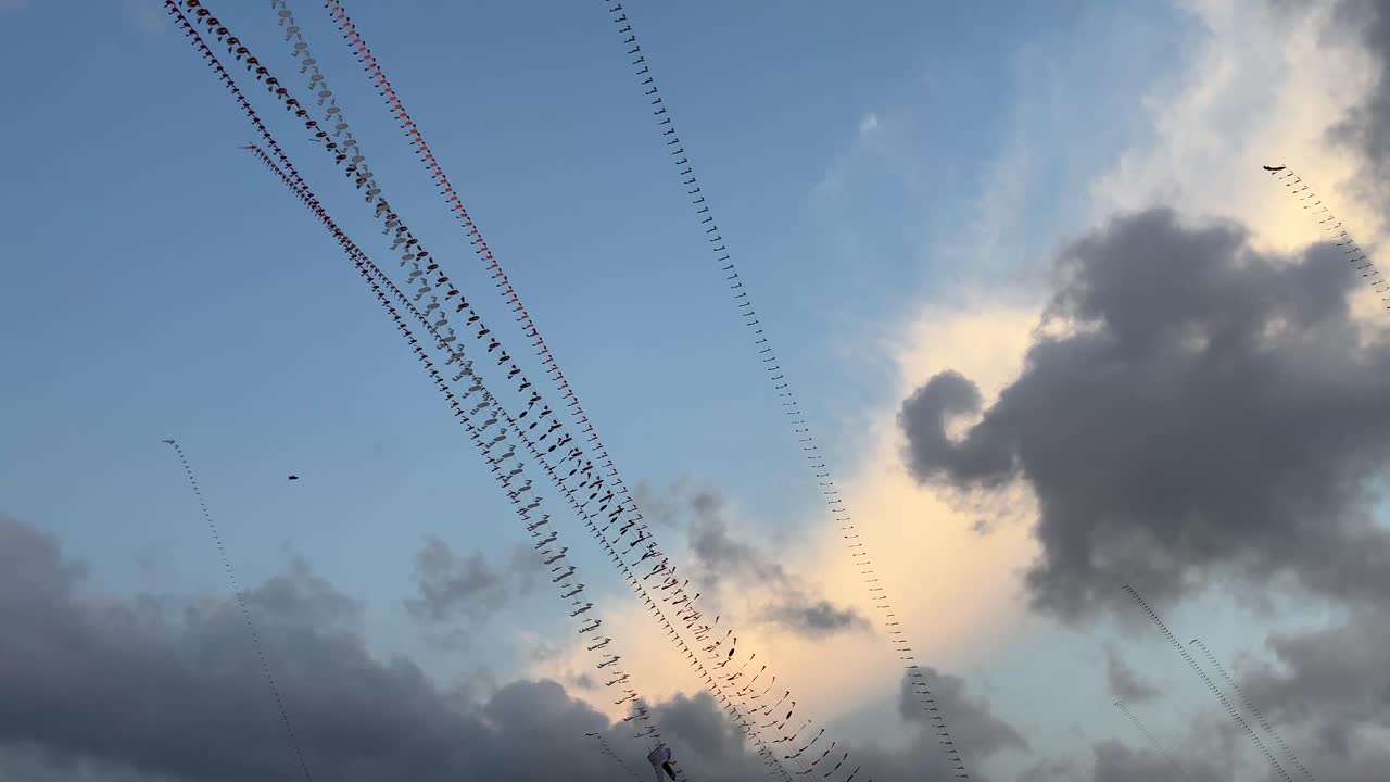 Dragon kites are flown against a backdrop of clouds and a bright and beautiful evening sky with natural afternoon lighting