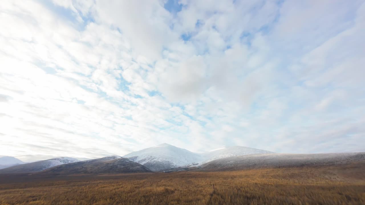 Stunning Winter Landscape: Snow-Covered Mountains and Expansive Field